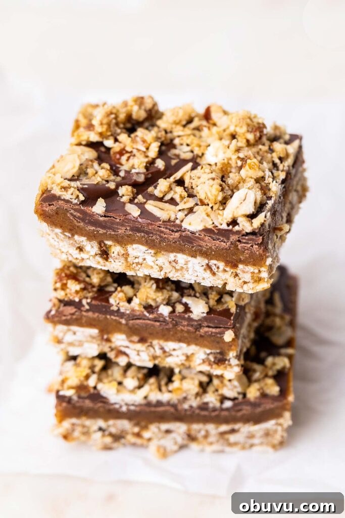 A stack of date bars with a chocolate fudge layer.