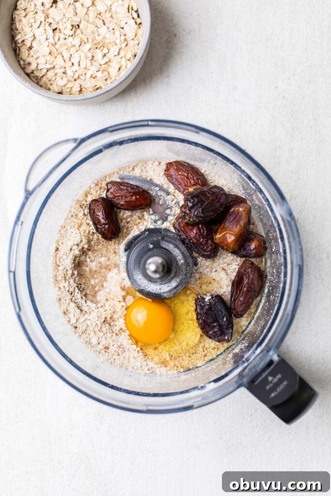 Adding the egg and dates to food processor bowl.