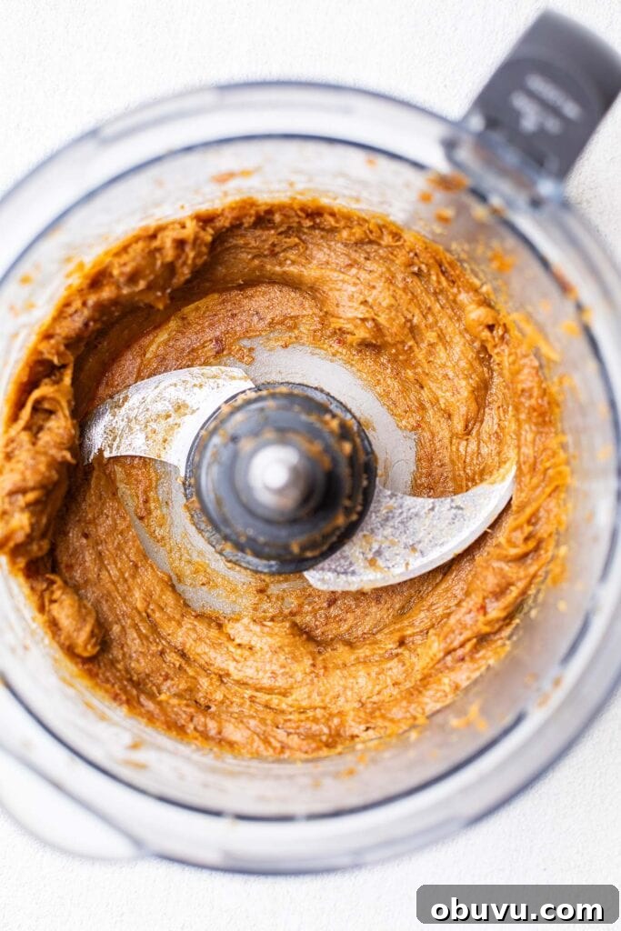 Smooth date caramel in a food processor bowl.