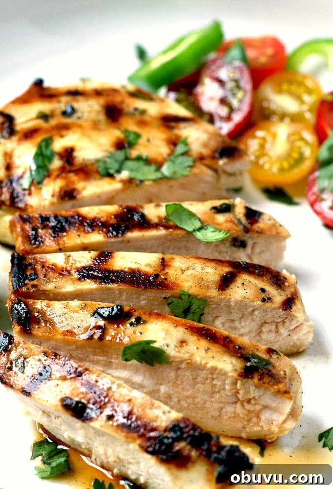 Tequila-Lime Margarita Chicken Recipe with Zesty Marinade 4 Close up of sliced lime tequila chicken breast on a white plate.