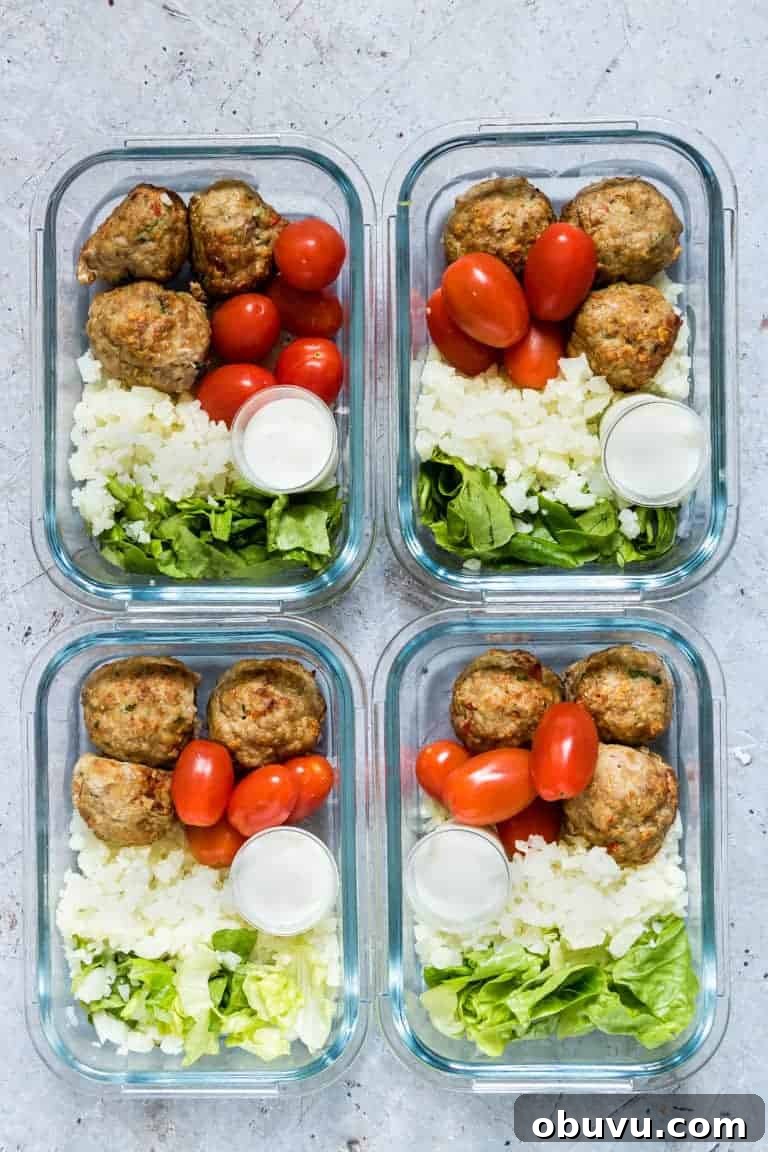 air fryer meatballs in meal prep bowls with cauliflower rice, lettuce and tomatoes