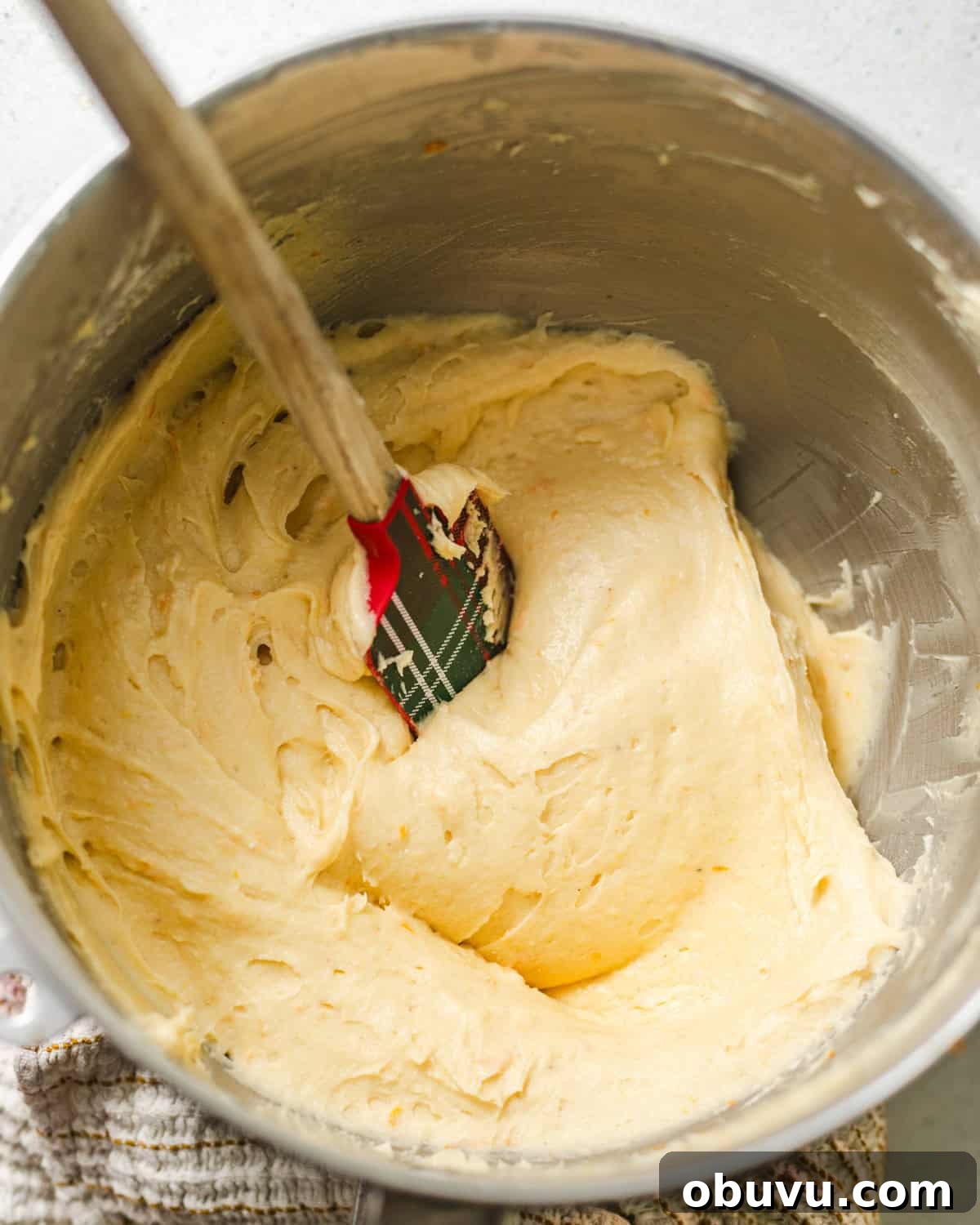 butter, sugar, oil, and orange zest creamed together in a bowl.