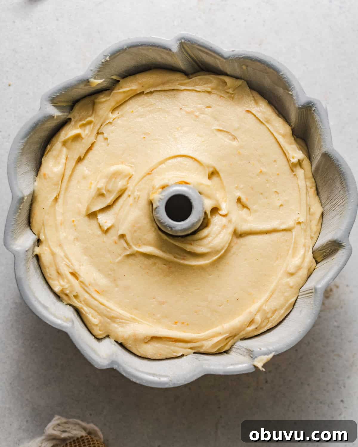 half of the cake batter poured into a bundt pan.