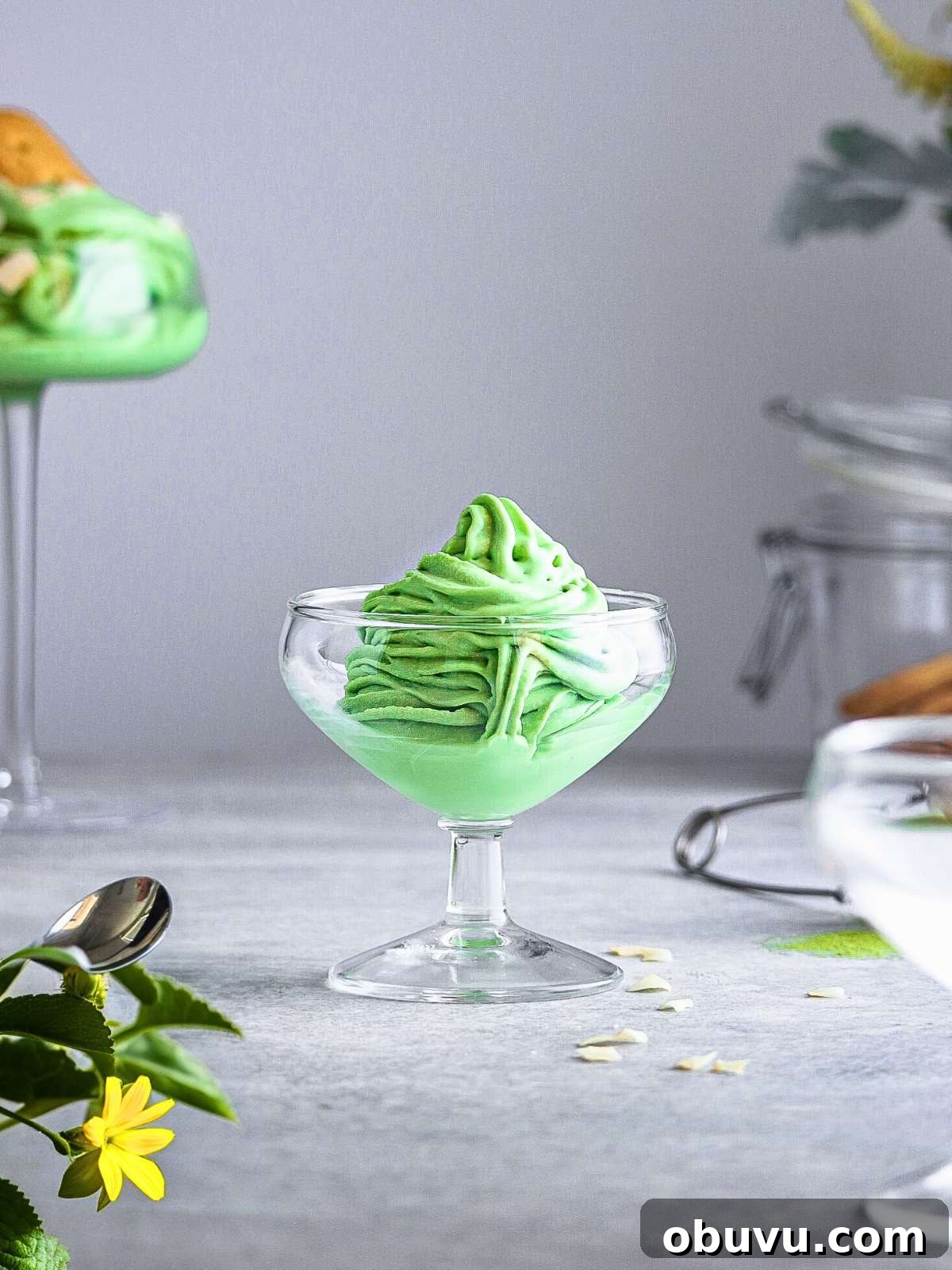 Creamy Matcha Ice Cream Recipe — Authentic Japanese Flavor 2 A serving of Soft serve matcha ice cream in a small glass cup.