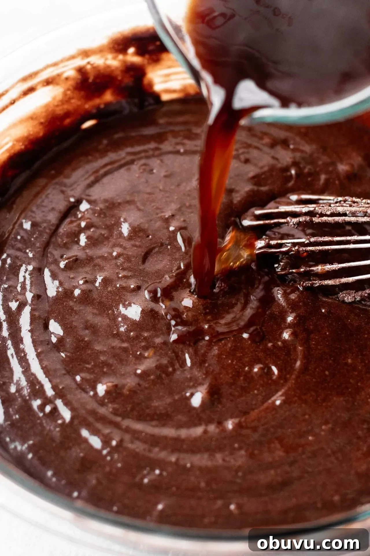 Decadent Gluten-Free Chocolate Cake Recipe 6 gluten free chocolate cake batter in bowl with cup of hot coffee being poured in