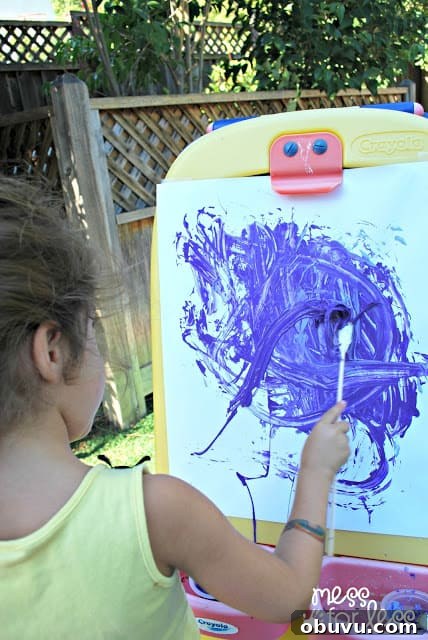 Creative Rubber Band Paintbrush Techniques for Unique Art 7 painting with rubber band paintbrushes on an easel