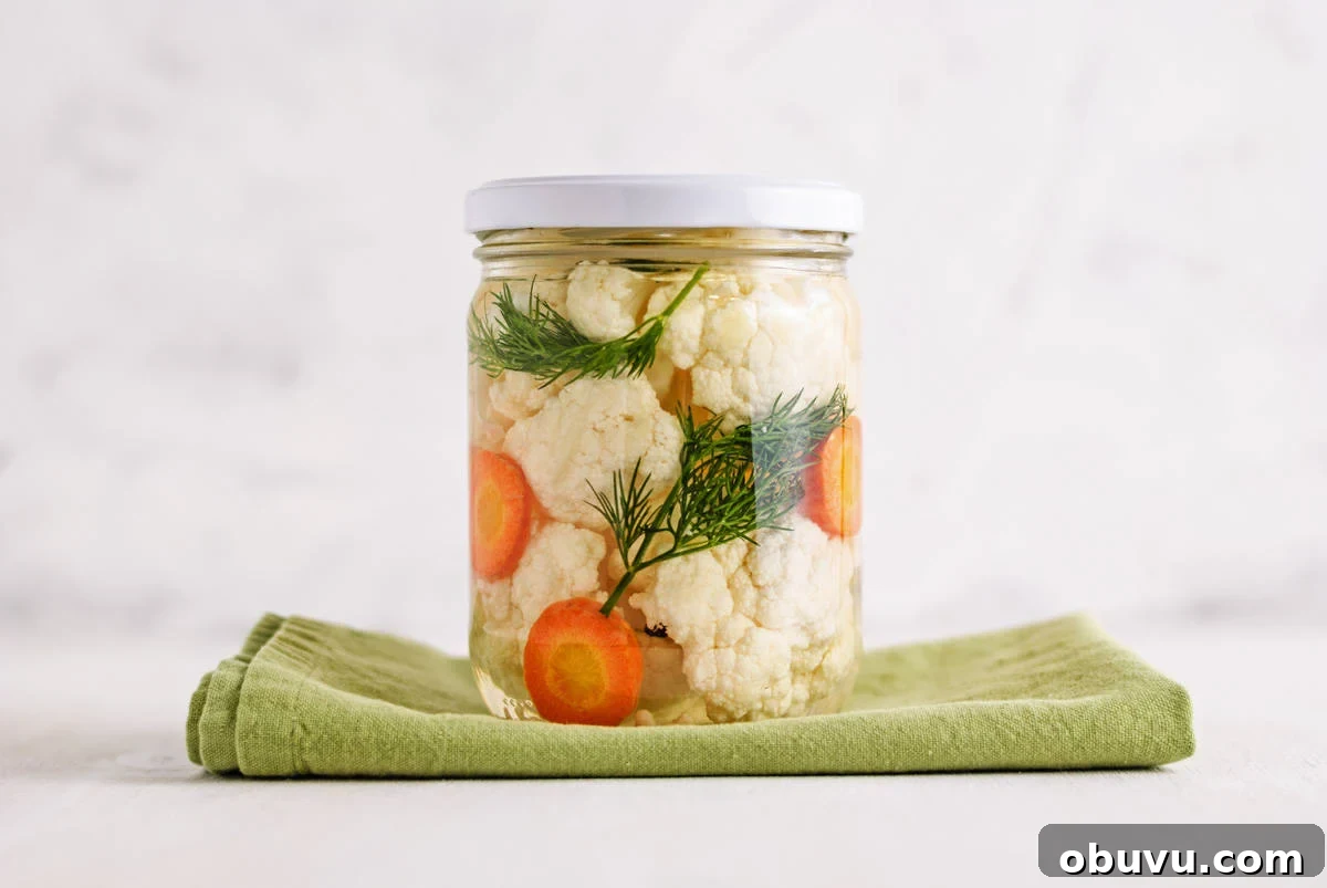 10 Essential Fermenting Supplies Every Home Preserver Needs 4 A jar with fermented cauliflower and carrots in it.