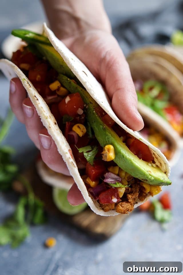 Vegan Tempeh Tacos with Savory Meat Filling 7 Hand Holding a Vegan Tempeh Taco