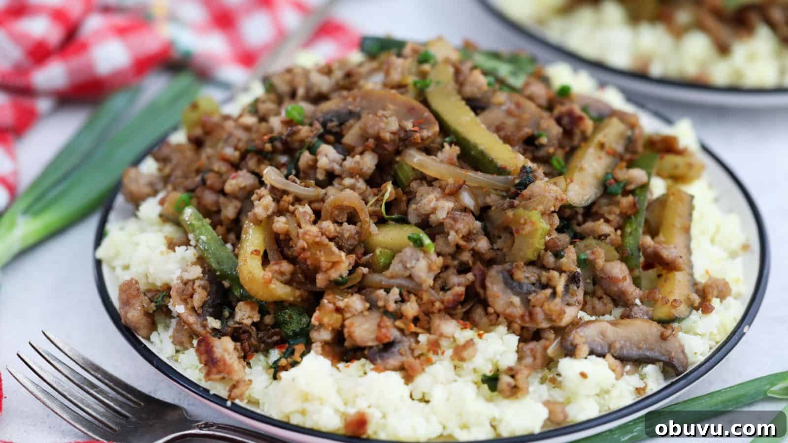29 Delicious Low-Carb Meals That Aren’t Just Salad 12 A plate with ground pork and vegetables on top of cauliflower rice.