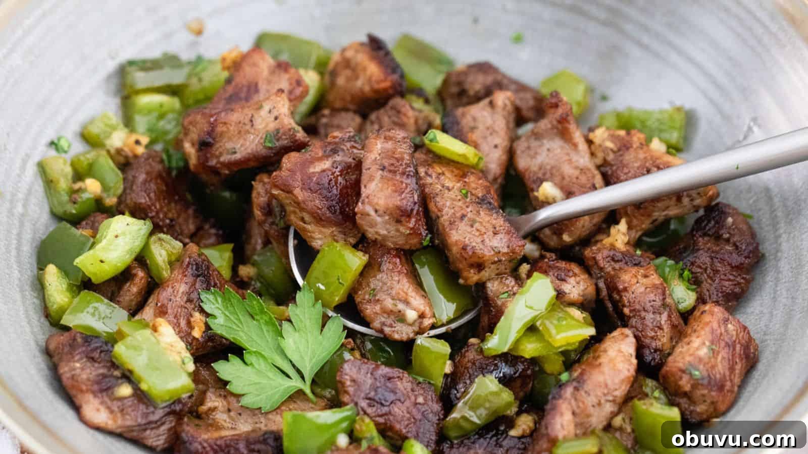 29 Delicious Low-Carb Meals That Aren’t Just Salad 25 A bowl of meat and green peppers with a spoon.