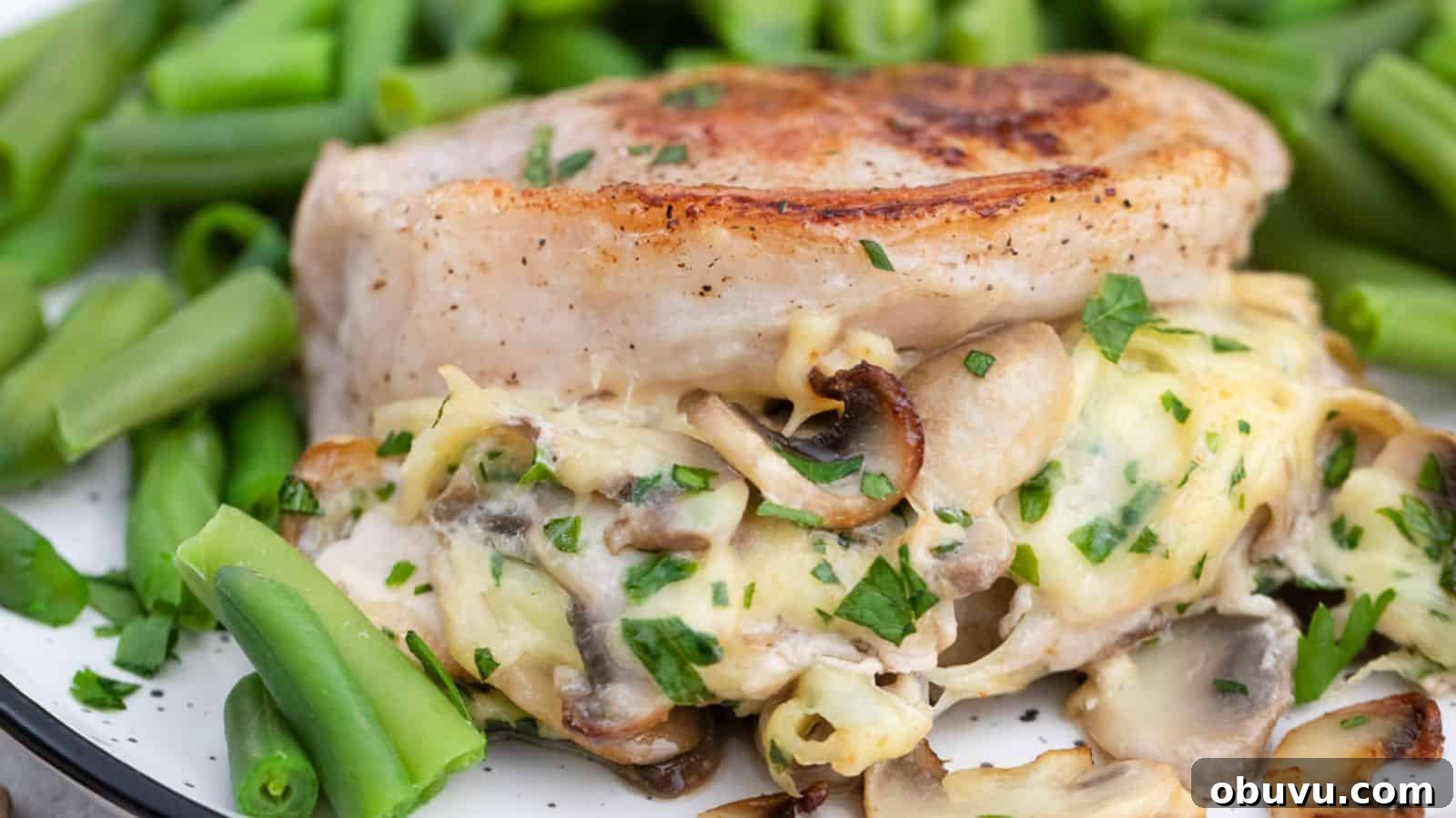 29 Delicious Low-Carb Meals That Aren’t Just Salad 26 A plate of pork chops stuffed with mushrooms and cheese served with green beans.