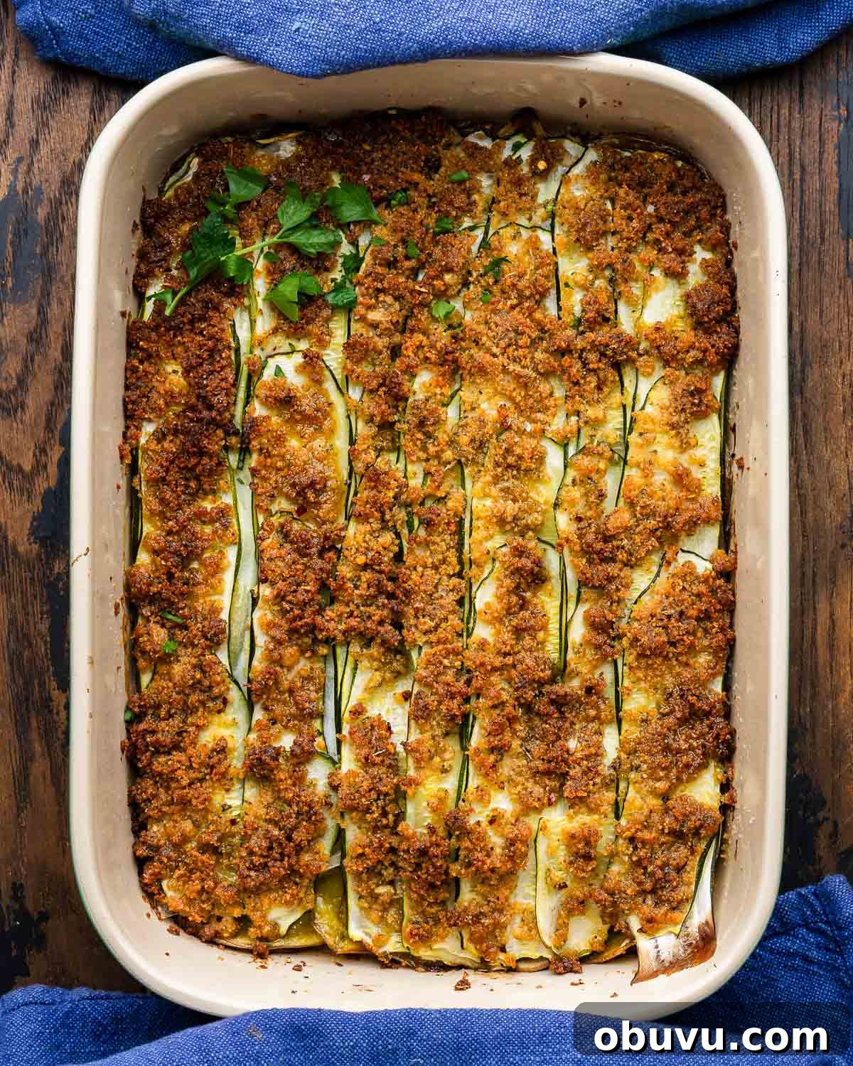 Zucchini and Potatoes al Forno: Crispy Oven-Baked Vegetable Side 2 Overhead shot of zucchini potato al forno topped with parsley garnish.