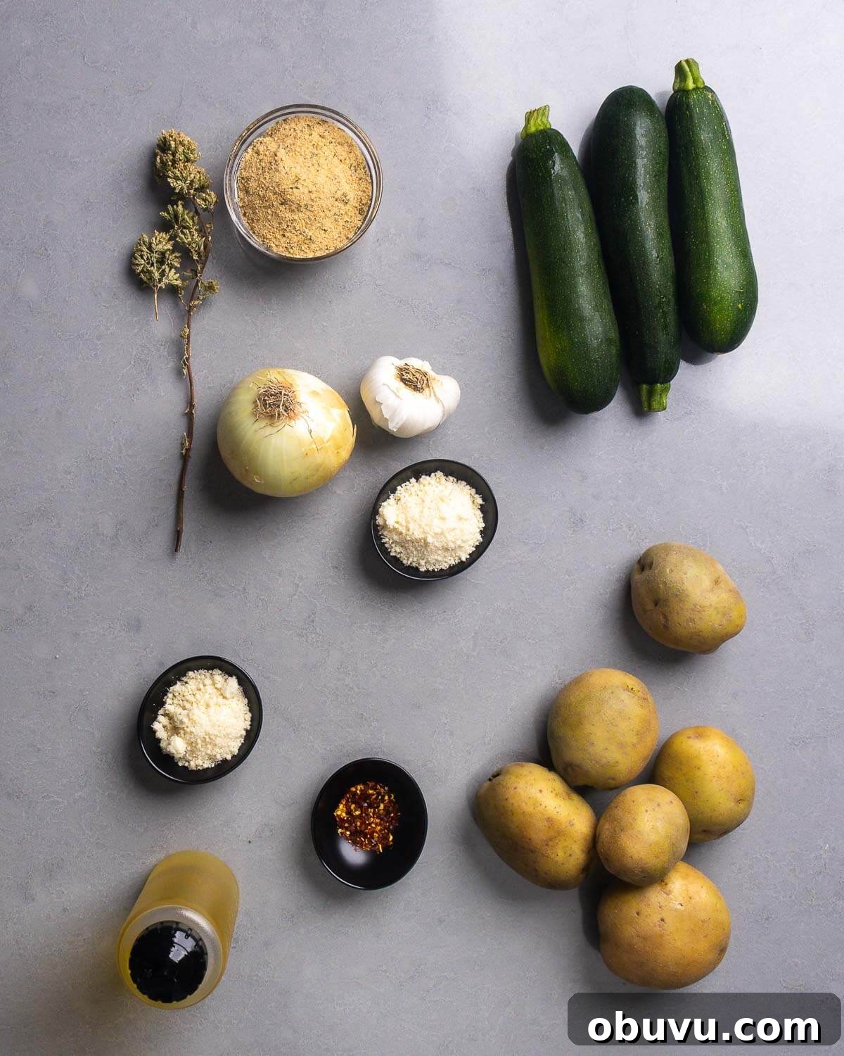 Zucchini and Potatoes al Forno: Crispy Oven-Baked Vegetable Side 4 Ingredients shown: sicilian oregano, breadcrumbs, onion, garlic, pecorino romano, zucchini, olve oil, hot red pepper flakes, and potatoes.