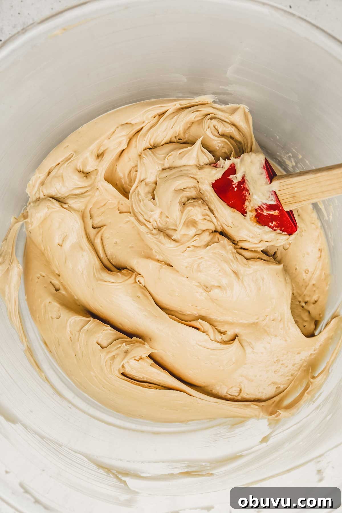 No-Bake Biscoff Cookie Butter Cheesecake Recipe 6 mixing cheesecake batter with an electric mixer