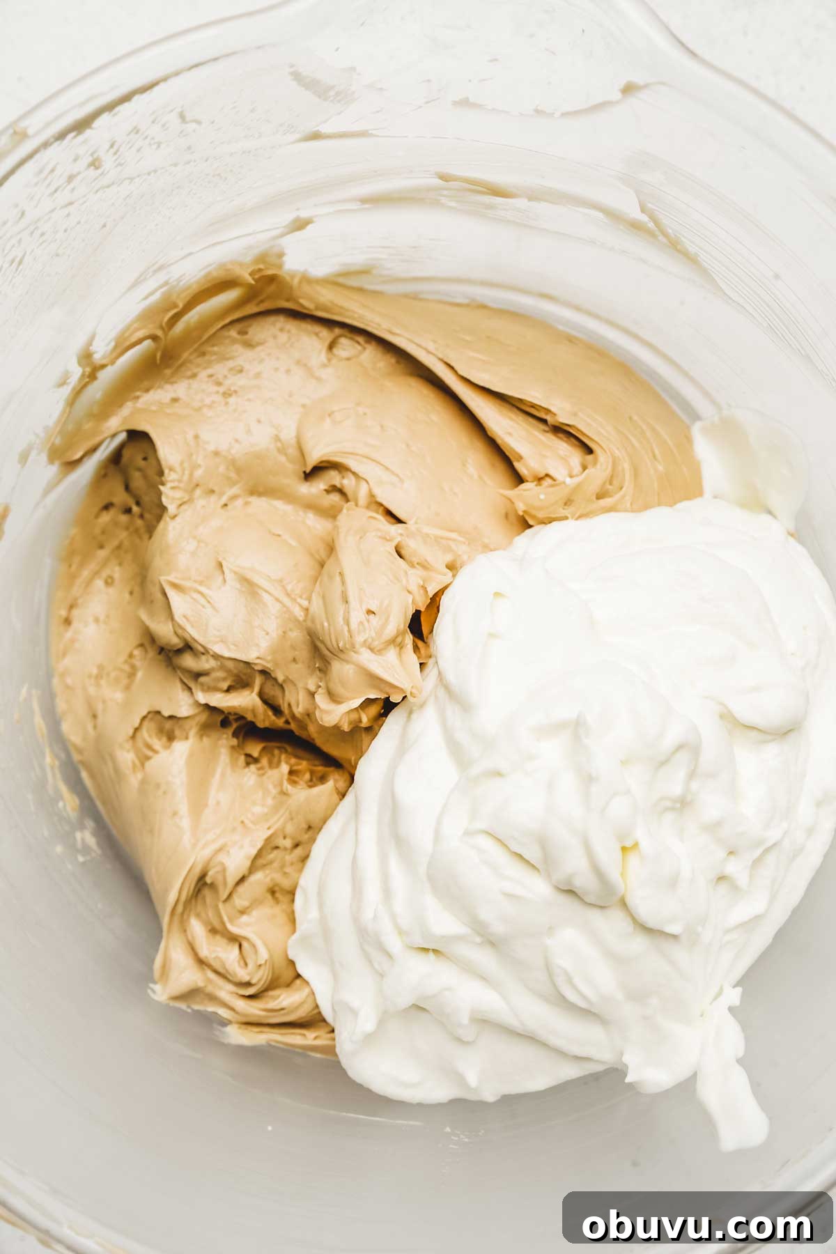 No-Bake Biscoff Cookie Butter Cheesecake Recipe 7 folding whipped cream into cookie butter cheesecake filling
