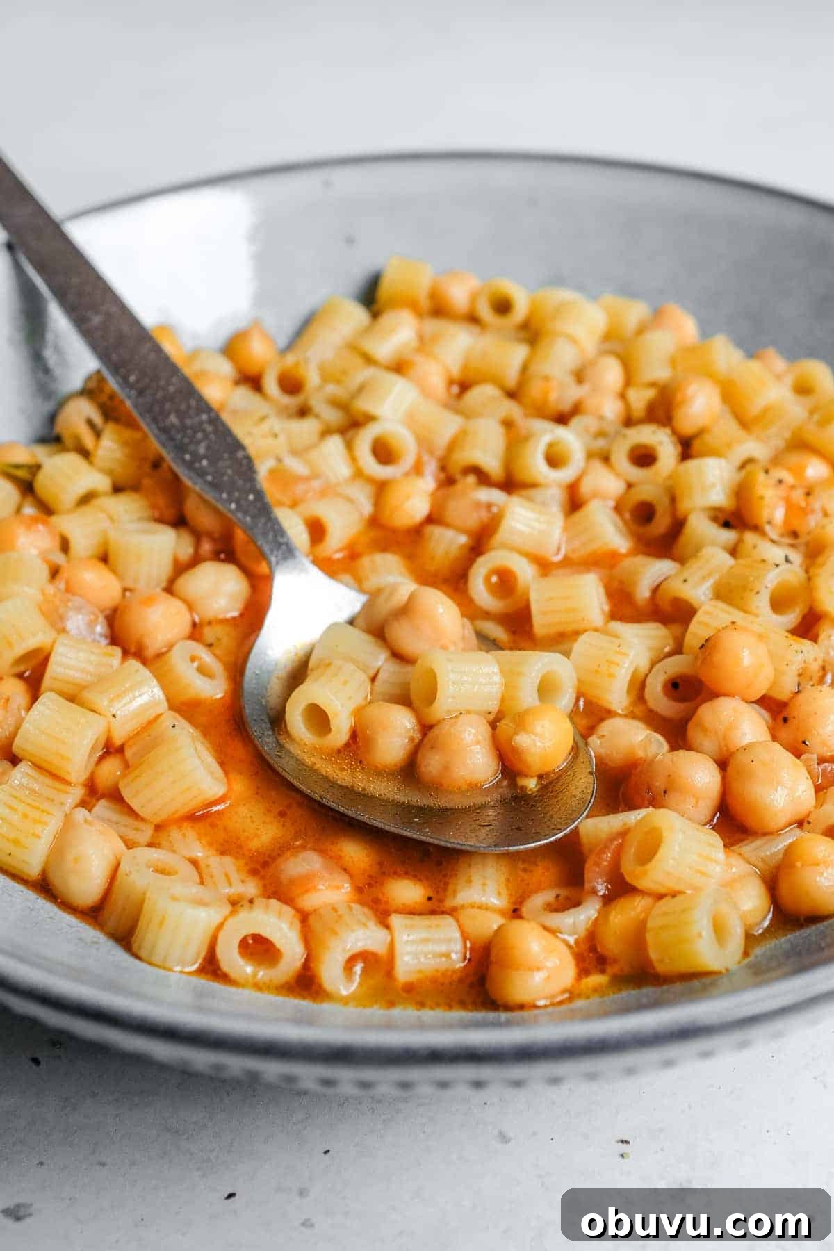 a bowl of Italian pasta e ceci with a spoon
