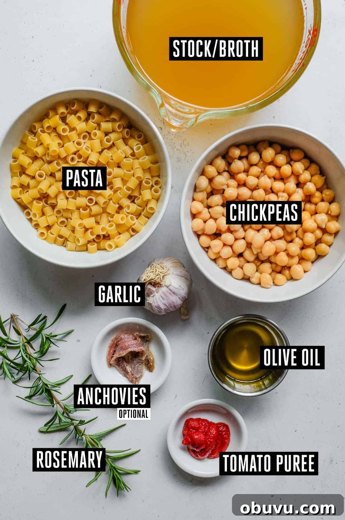 the ingredients for pasta e ceci - stock, chickpeas, ditalini pasta, anchovies (optional), garlic, rosemary, oil, tomato paste.
