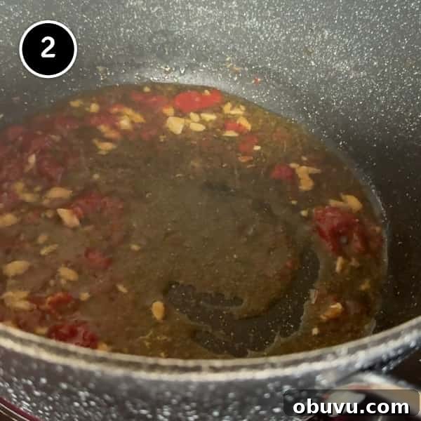 frying garlic, anchovies and tomato paste in a pot