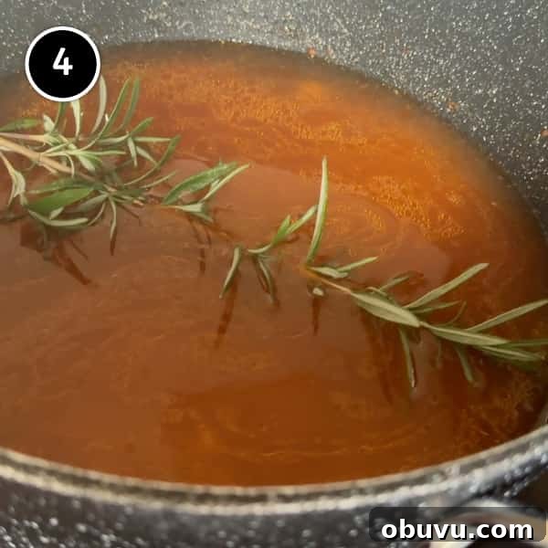 adding the broth and rosemary to the pot