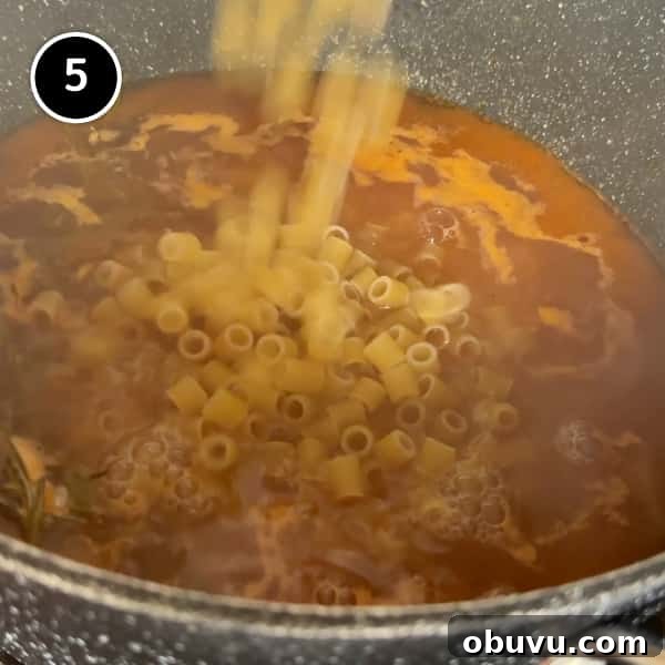 adding the pasta to the simmering sauce