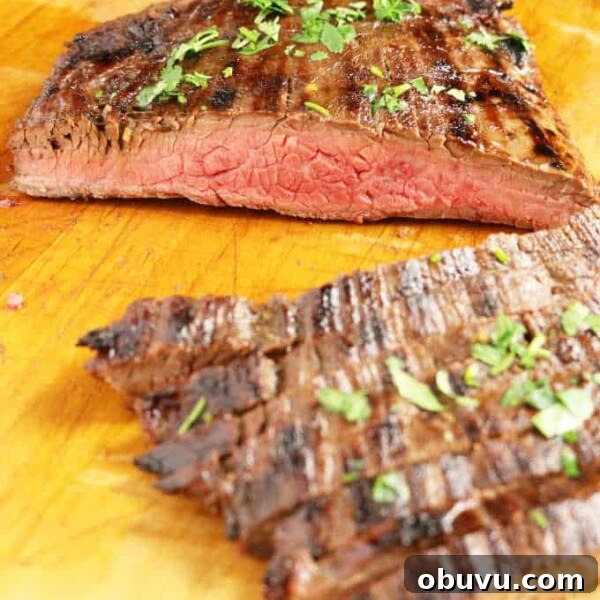 Maple Bourbon Smash Cocktail Recipe — Warm Autumn Whiskey Smash 11 grilled flank steak on wood cutting board sliced into strips medium rare, veggies in background