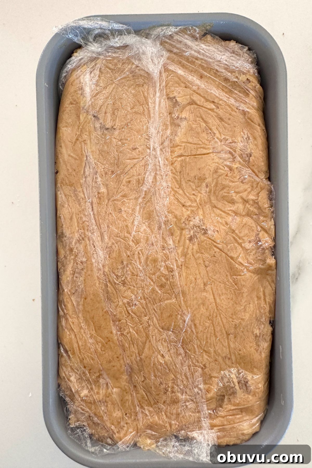 No-Bake Pumpkin Icebox Cake for Fall Desserts 6 Pumpkin icebox cake assembled and covered with plastic wrap, ready to chill overnight.