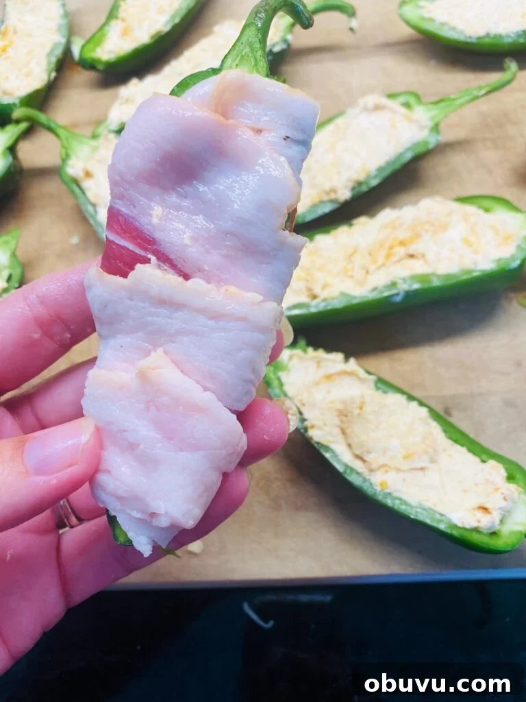 Smoked Honey Jalapeño Poppers with Creamy Cheese Filling 6 wrapping the poppers with bacon