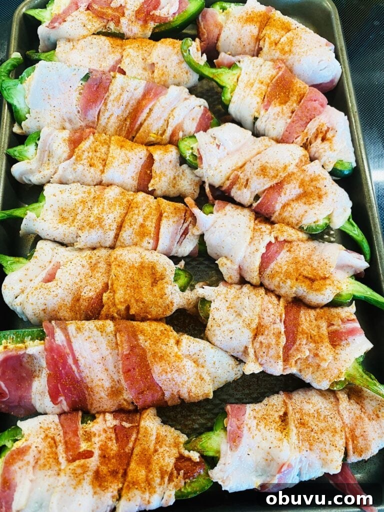 Smoked Honey Jalapeño Poppers with Creamy Cheese Filling 7 seasoning more over the wrapped jalalepnos