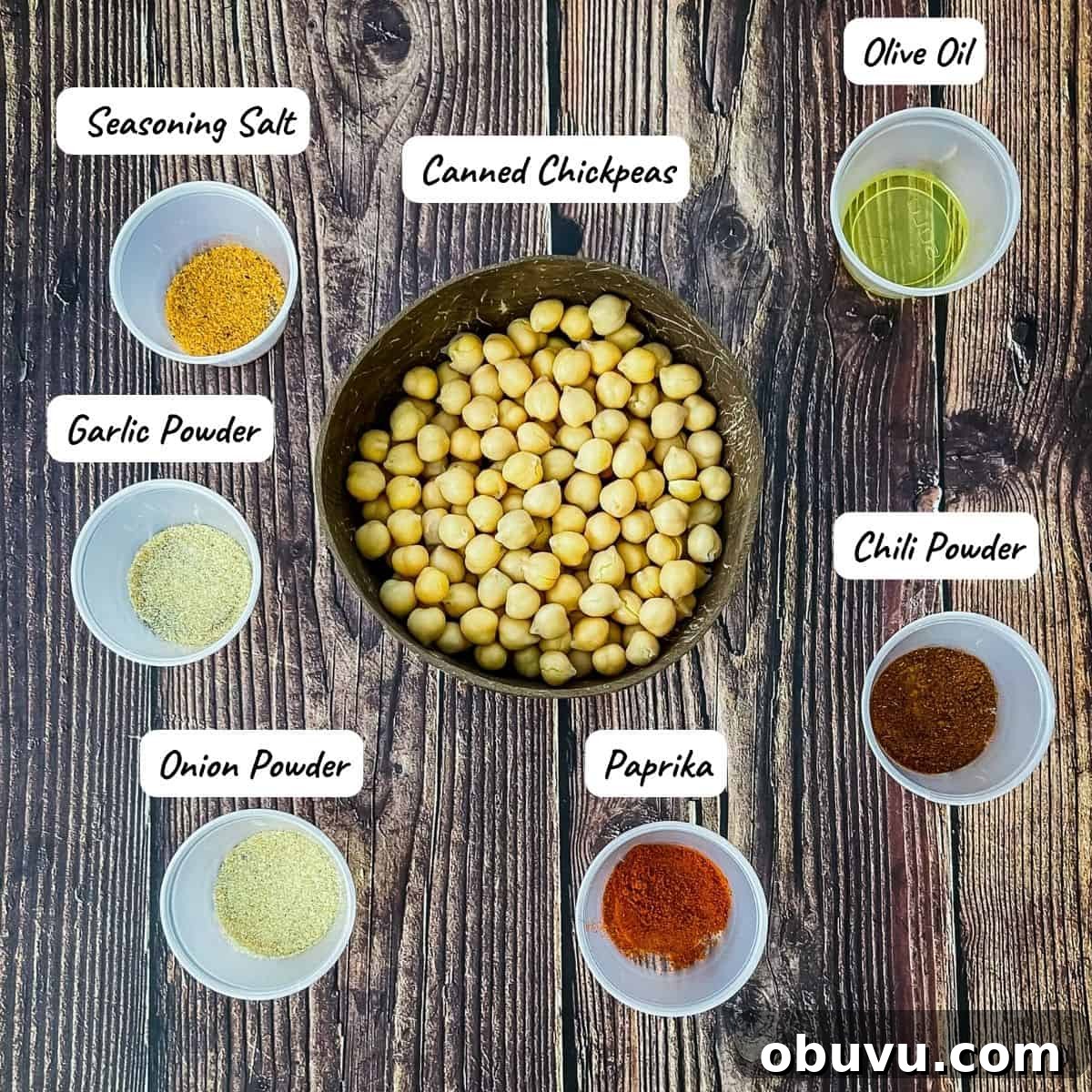 The ingredients needed to make air fryer chickpeas measured out and placed on a wood table.