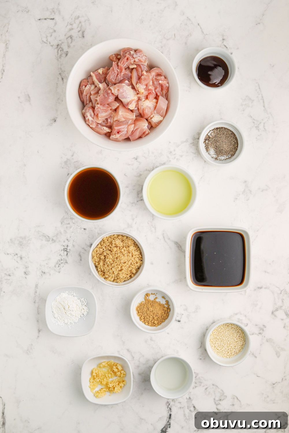 30-Minute Bourbon Chicken Skillet Recipe That Beats Takeout 6 all the ingredients in small single serve bowls on table for making Bourbon Chicken Skillet