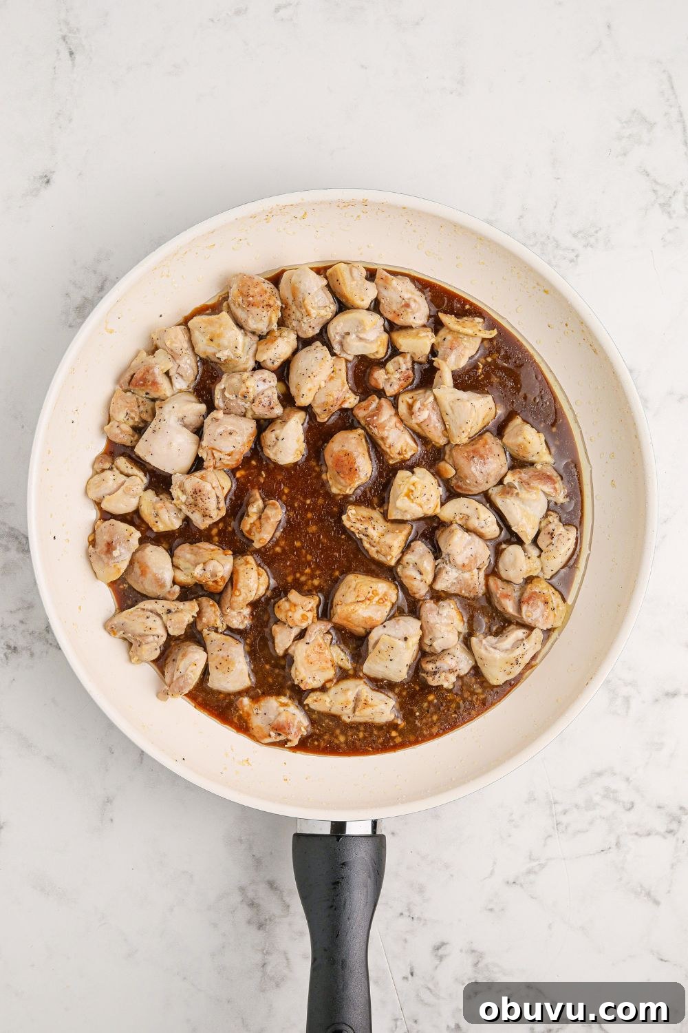 30-Minute Bourbon Chicken Skillet Recipe That Beats Takeout 9 diced chicken cooked and poured with sauce in a skillet on table