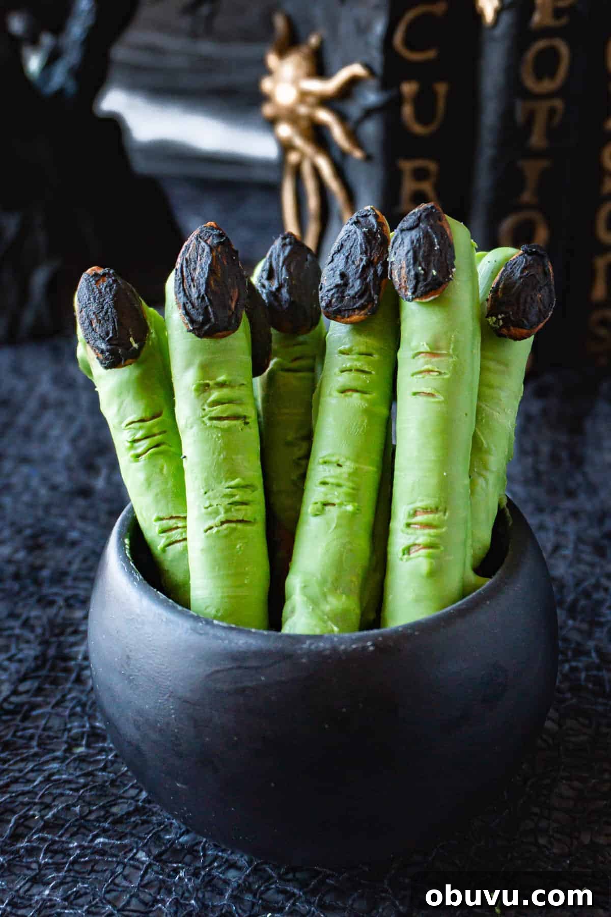 Witch Finger Cookies Recipe: Spooky Halloween Treats 2 green witches fingers in a black bowl.