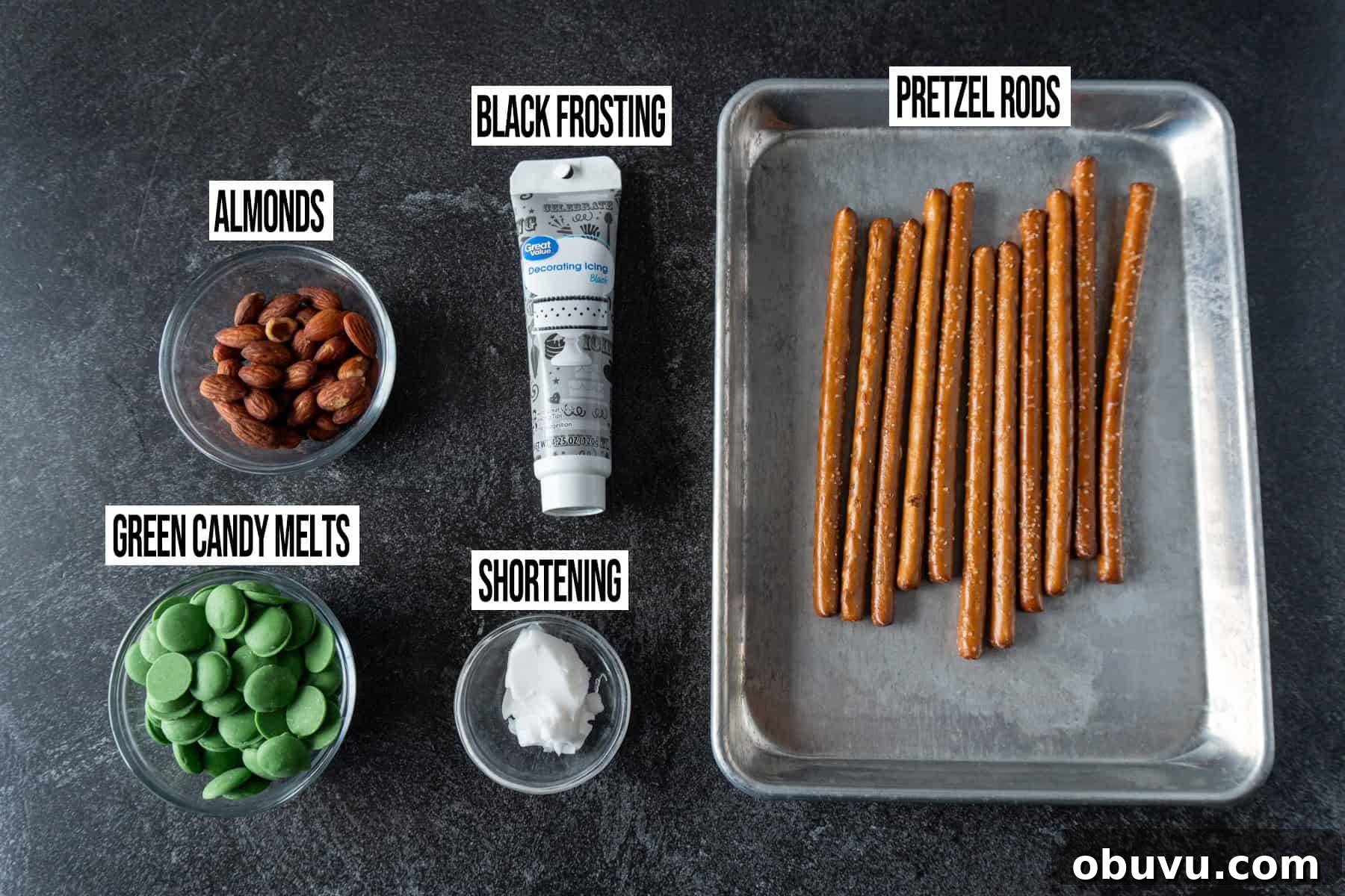 Witch Finger Cookies Recipe: Spooky Halloween Treats 4 Witches Fingers Pretzel Rods ingredients in individual bowls and labeled.