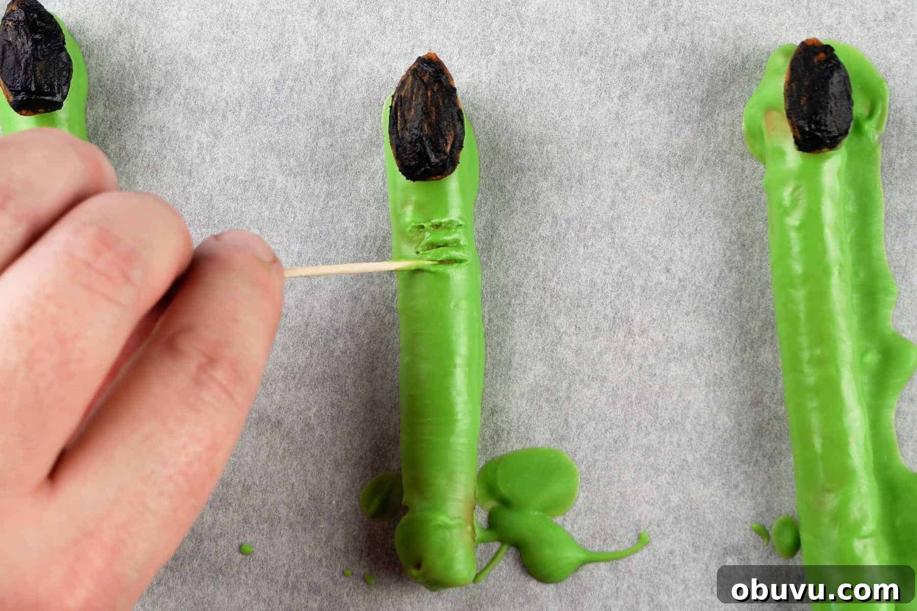 Witch Finger Cookies Recipe: Spooky Halloween Treats 8 using a toothpick to create knuckle marks on witch finger.
