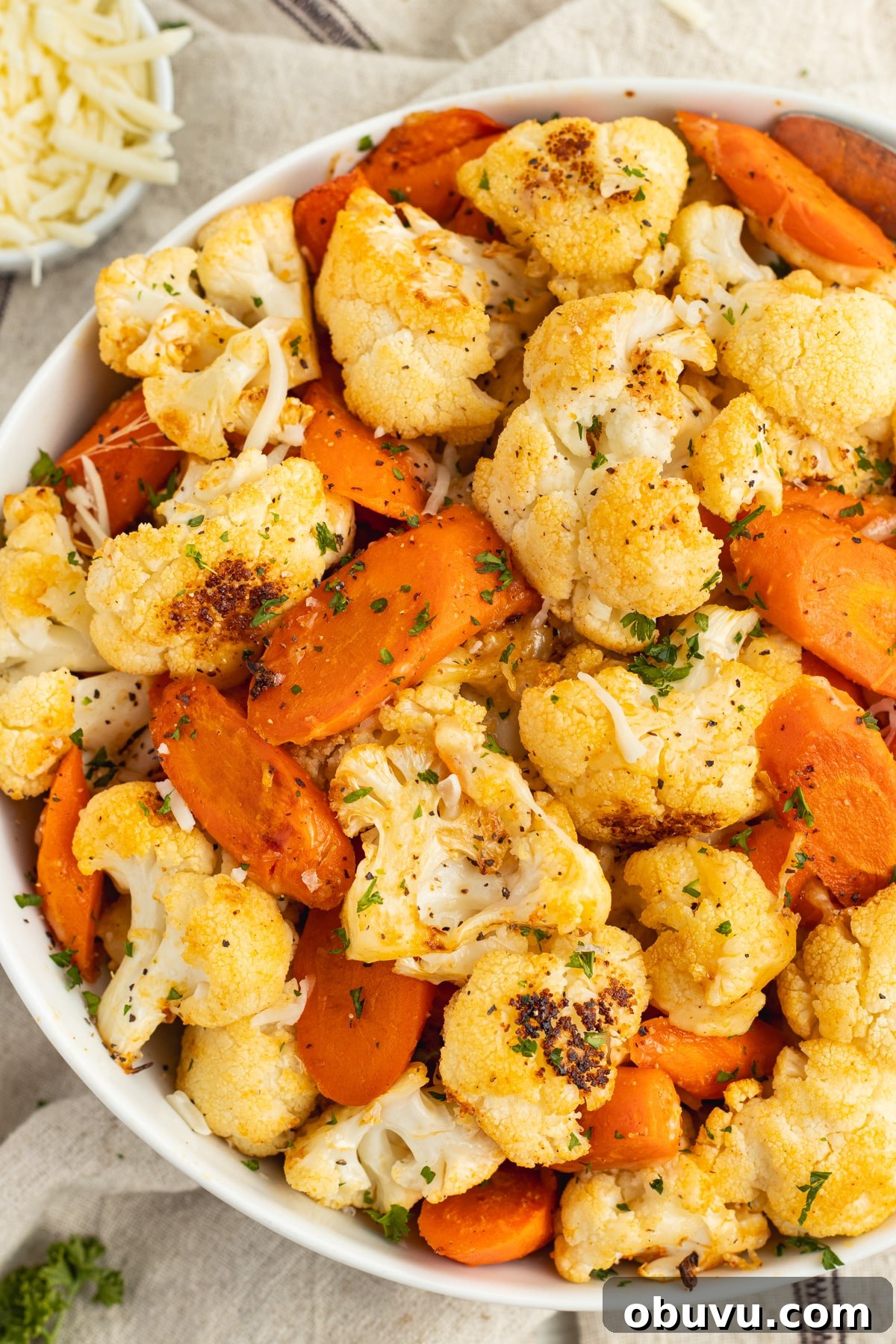 Roasted Carrots and Cauliflower in Cheesy Garlic Crust 2 This is a picture of a bowl filled with cheesy roasted carrots and cauliflower.