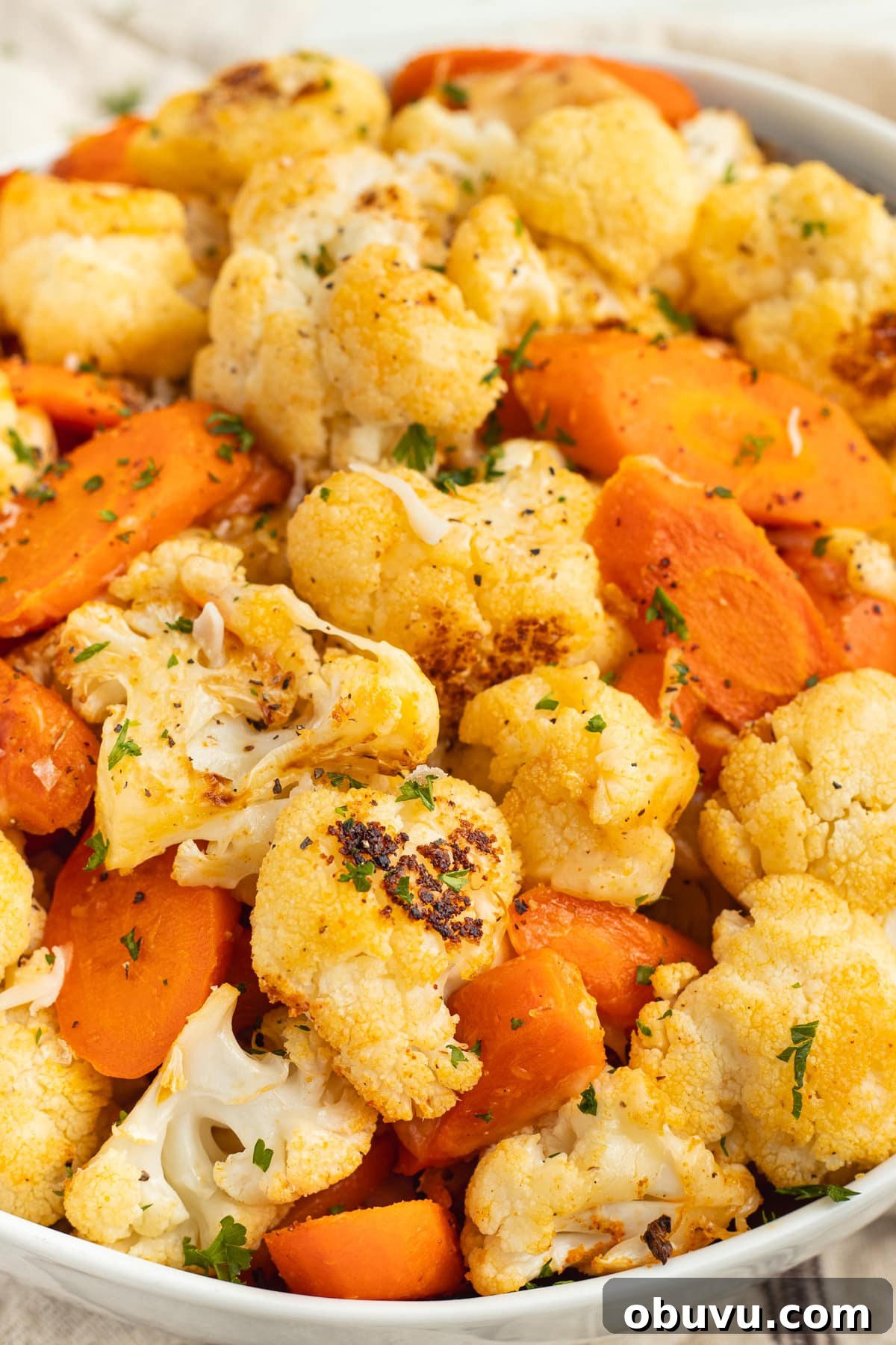 Roasted Carrots and Cauliflower in Cheesy Garlic Crust 9 This is a picture of a bowl filled with cheesy carrots and cauliflower.