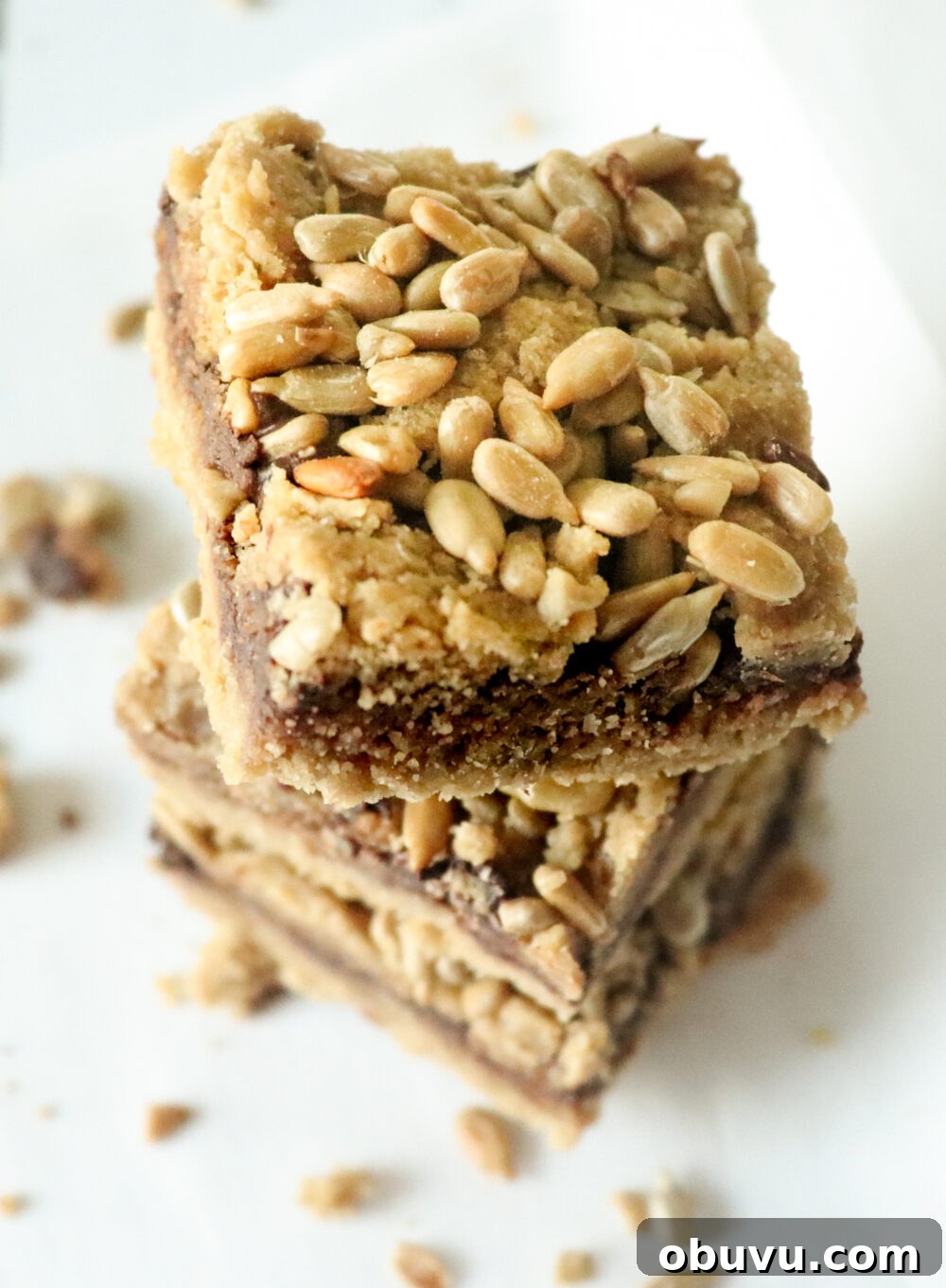 three stacked keto cookie bars topped with sunflower seeds