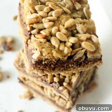 three stacked keto cookie bars topped with sunflower seeds