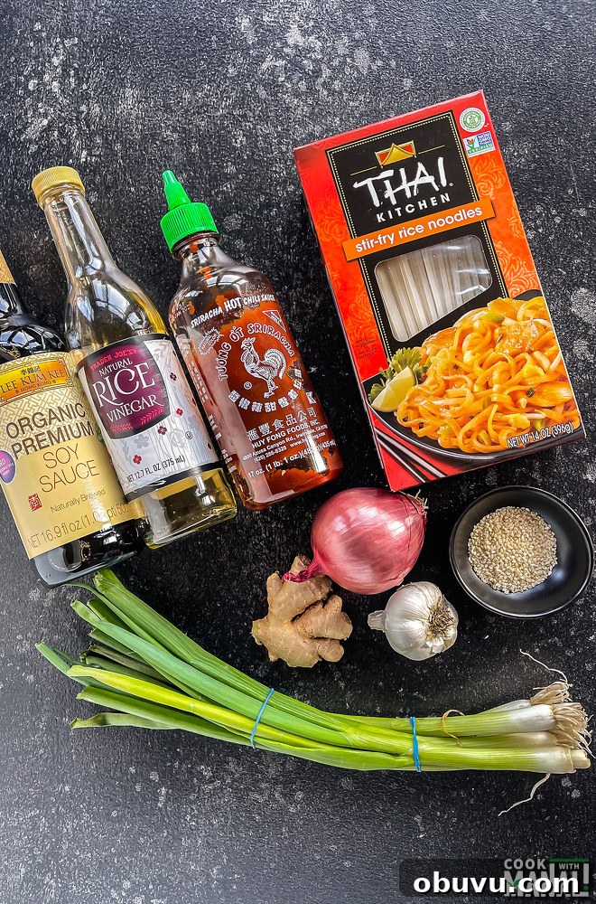 bottles of soy sauce, hot sauce, vinegar, packet of noodles, garlic-ginger arranged together