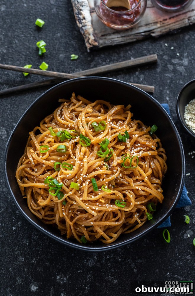 bowl of noodles with chopsticks placed on the side