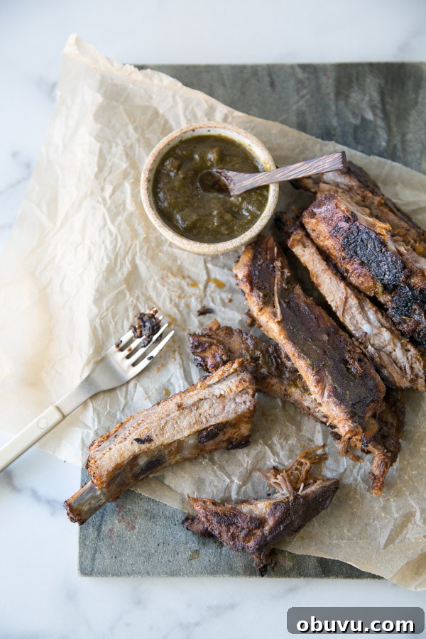 Slow-Roasted Baby Back Ribs in 2½ Hours: Tender, Fall-Off-Bone 2 oven baked baby back ribs on a platter with homemade bbq sauce