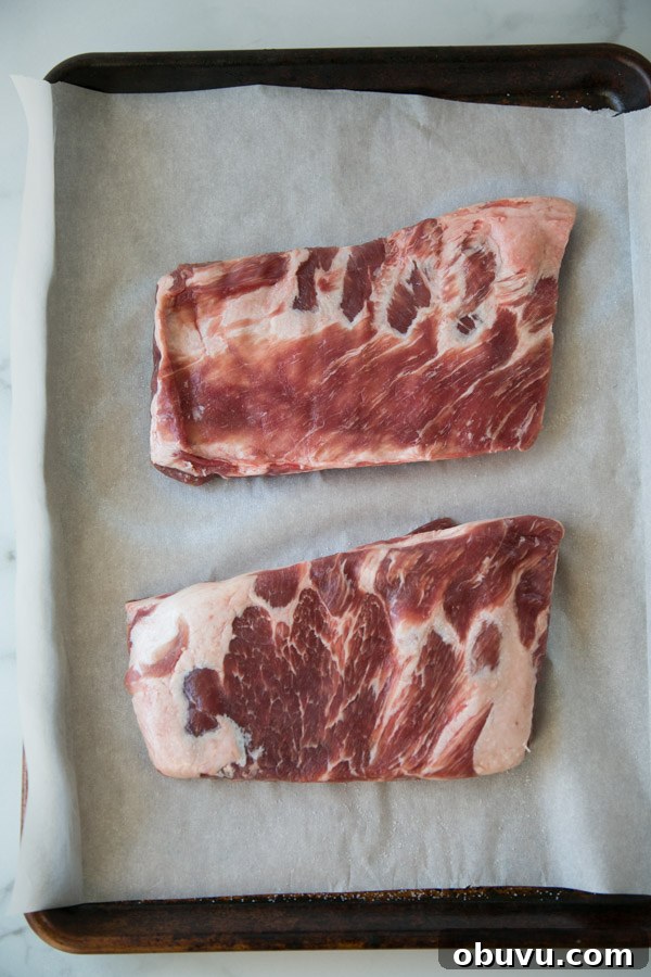 Slow-Roasted Baby Back Ribs in 2½ Hours: Tender, Fall-Off-Bone 3 baby back ribs on a sheet pan