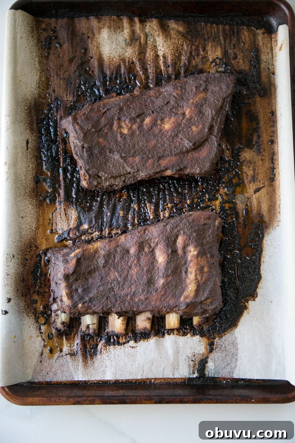 Slow-Roasted Baby Back Ribs in 2½ Hours: Tender, Fall-Off-Bone 7 Whole rack of Oven baked Baby Back Ribs on a sheet pan