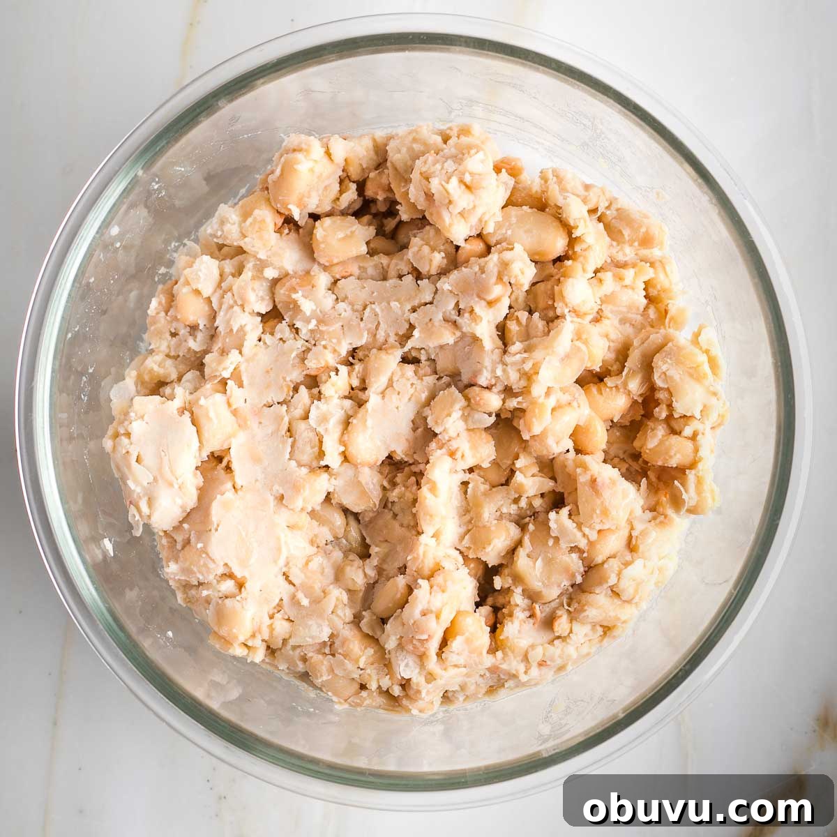 Crispy Vegan Chicken Salad with Creamy Herb Dressing 5 Mashed cannelllini beans in a glass bowl.