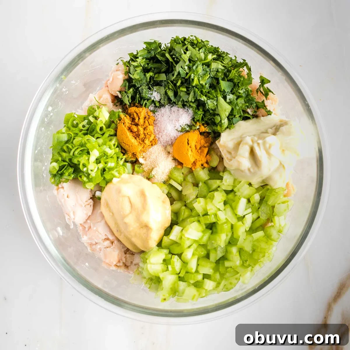 Crispy Vegan Chicken Salad with Creamy Herb Dressing 6 Glass bowl filled with mashed beans plus herbs, spices minced veggies to create vegan chicken salad.