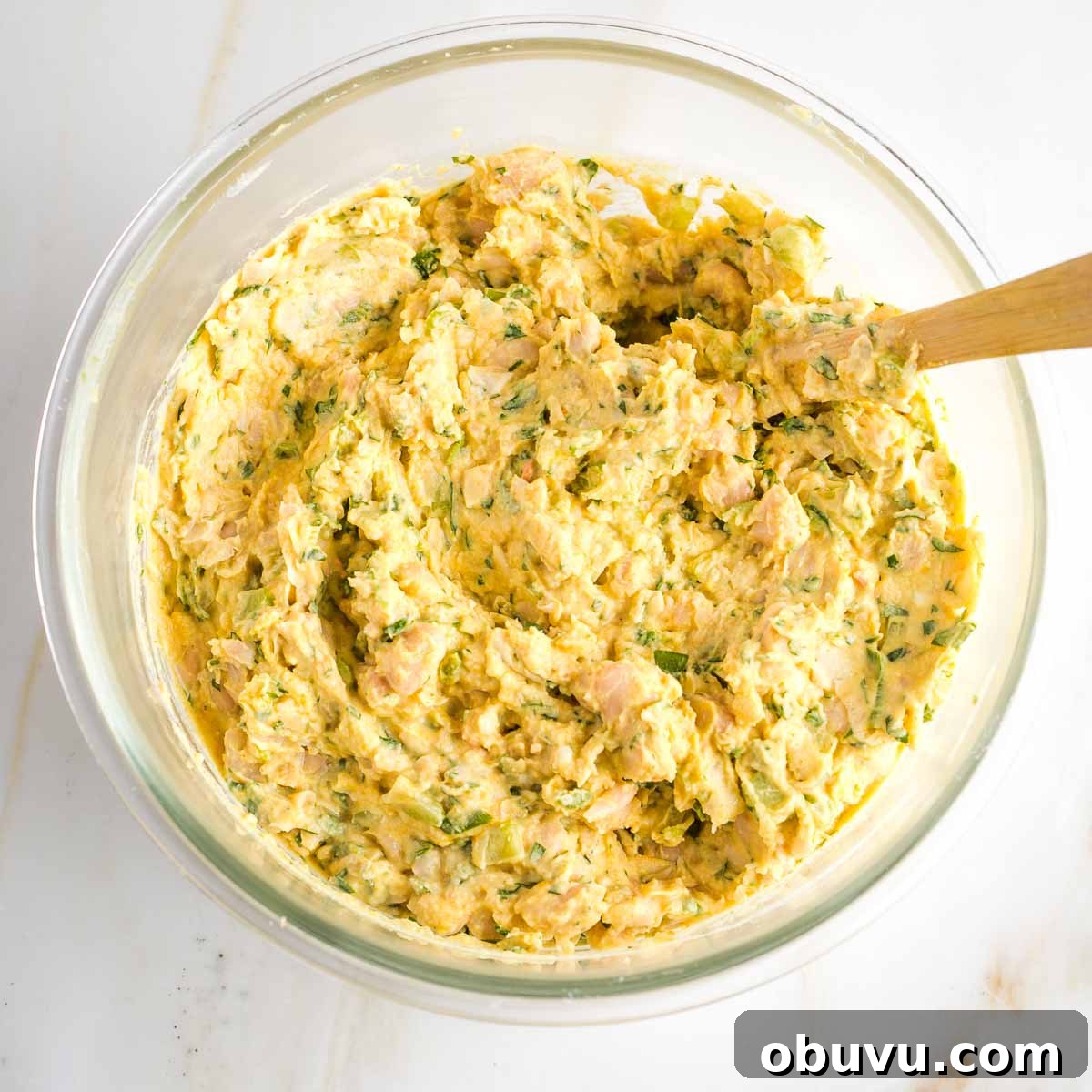 Crispy Vegan Chicken Salad with Creamy Herb Dressing 7 Vegan chicken salad with varied textures in a glass bowl.