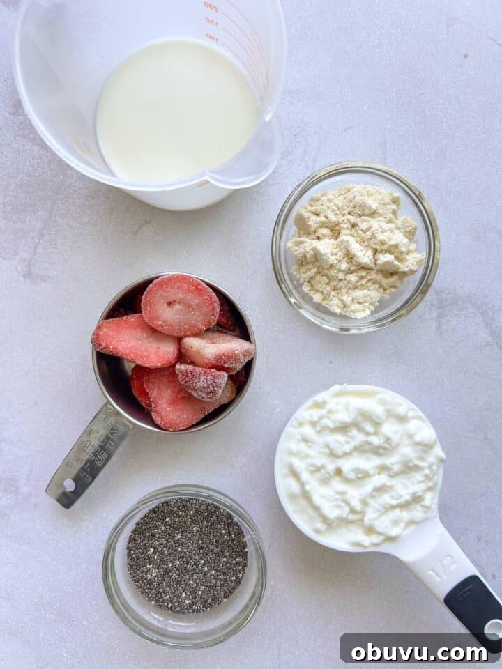 Blended Strawberry Cheesecake Chia Pudding Recipe 4 Ingredients for strawberry cheesecake chia pudding displayed in a small bowls on a white kitchen counter