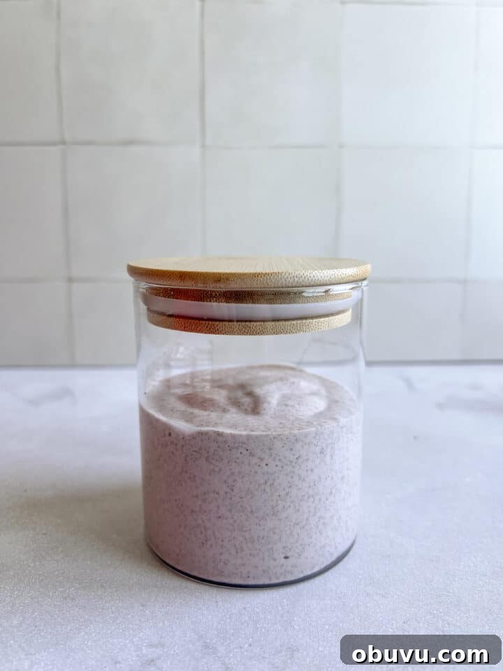 Blended Strawberry Cheesecake Chia Pudding Recipe 6 Blended strawberry cheesecake chia pudding in a glass jar with a bamboo lid