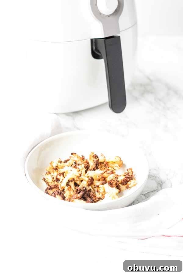 Crispy Air Fryer Frozen Cauliflower in 15 Minutes 6 This Air Fryer frozen cauliflower recipe turns into the most delicious roasted cauliflower. A great side dish that is on the table in no time. No mushy smells while cooking. Season with your favorite seasoning. A new family favorite.