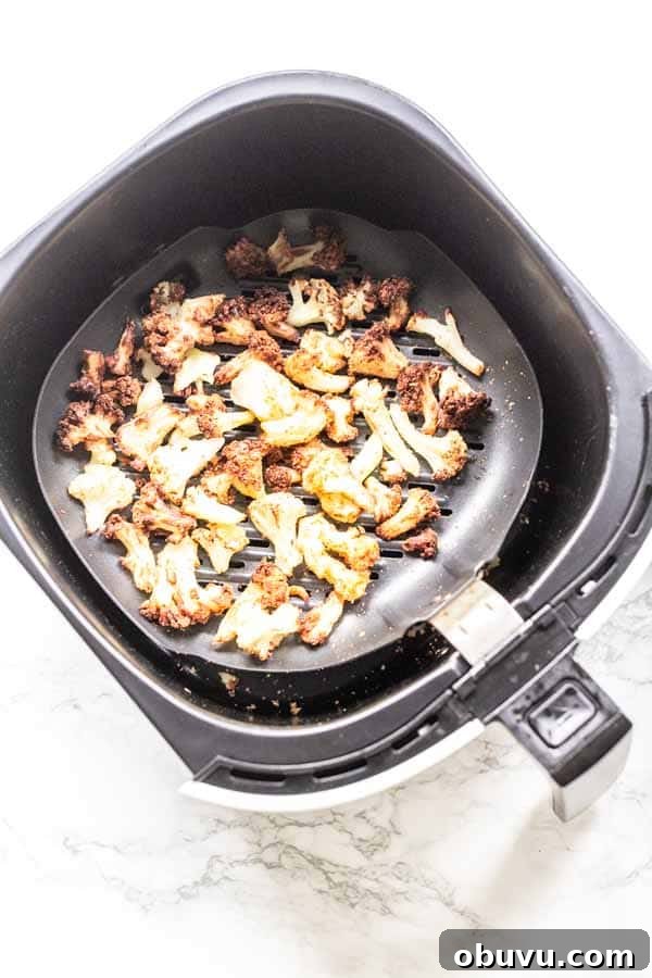 Crispy Air Fryer Frozen Cauliflower in 15 Minutes 10 This Air Fryer frozen cauliflower recipe turns into the most delicious roasted cauliflower. A great side dish that is on the table in no time. No mushy smells while cooking. Season with your favorite seasoning. A new family favorite.